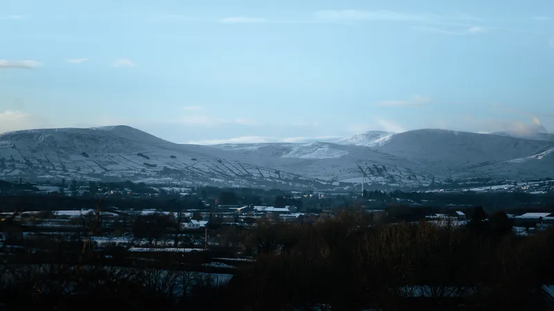 Snow-dusted hills above a town in winter